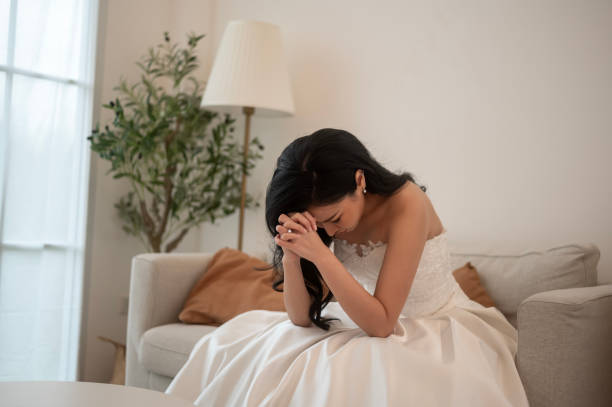 istock Sad and worried bride crying and arguing with groom in wedding day 1902297719