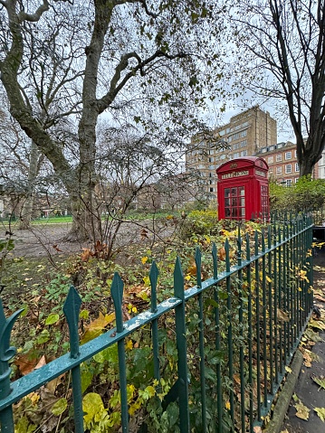 Traditional telephone box  and Big Ben at the background.Simulation of film 400iso.