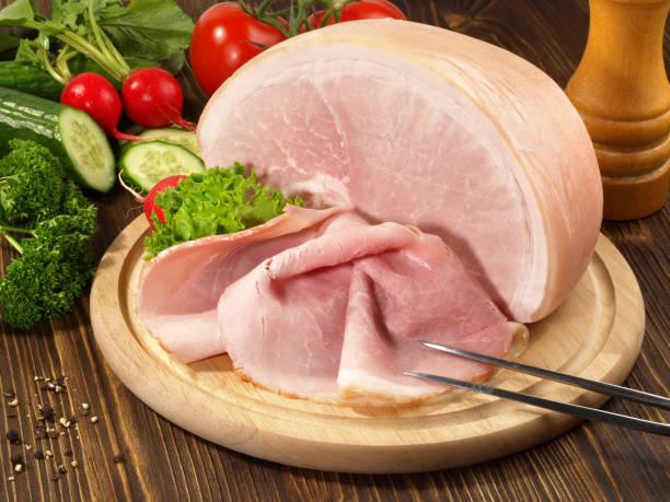 istock Cooked Ham Slices on a wooden Plate 1902309865