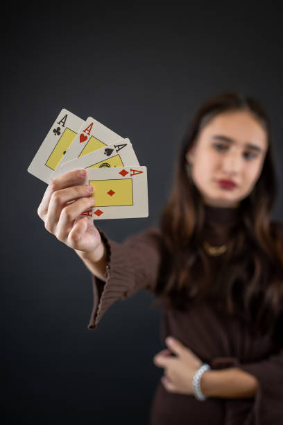 istock Beautiful poker player holding four aces isolated on black 1902312782
