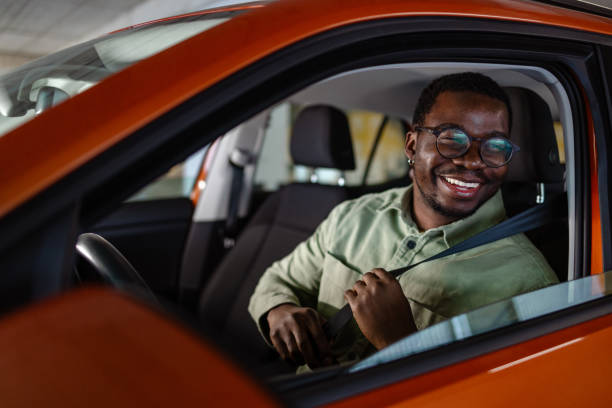 istock Young African American man starting a car ride 1902322417