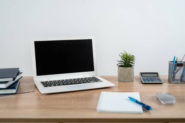 istock Empty notepad with pen laptop calculator coffee on a office wooden surface, nobody 1902322422