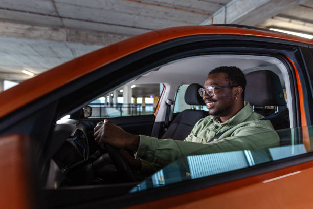 istock Young African-American man leaving a garage with his car 1902322426