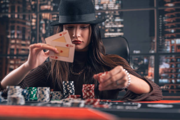 istock female player holding ace playing cards as win combination in poker game 1902324125