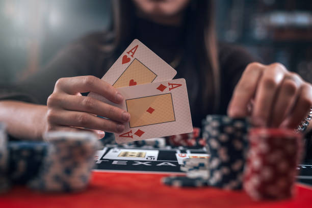 istock Female poker player hold two ace cards as winning game 1902324713