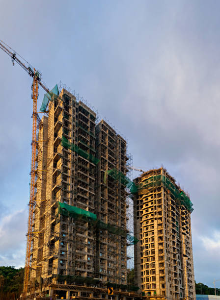 istock Beautiful blue sky behind two tall buildings in Sunlight , under construction in fast growing city of Pune, India. 1902346397