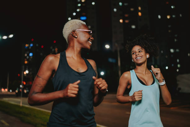 istock Two young women exercising at night 1902357991