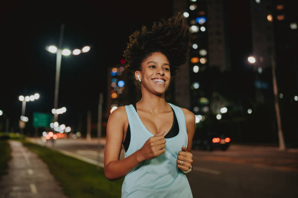 A young woman exercising at night running