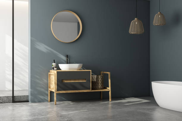 istock Modern minimalist bathroom interior, modern bathroom cabinet, white sink, wooden vanity, interior plants, bathroom accessories, bathtub and shower, white and blue walls, concrete floor. 1902375571