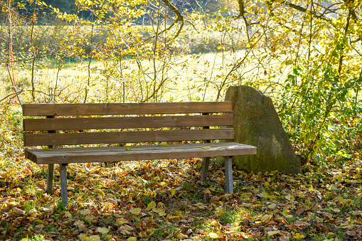 A wooden bench in front of the wonderful landscape over Bad Staffelstein, Franconia, Bavaria, Germany in autumn.