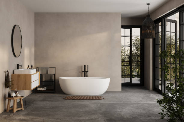 istock Modern minimalist bathroom interior, modern bathroom cabinet, white sink, wooden vanity, interior plants, bathroom accessories, bathtub and shower, white and beige walls, concrete floor. 1902398644