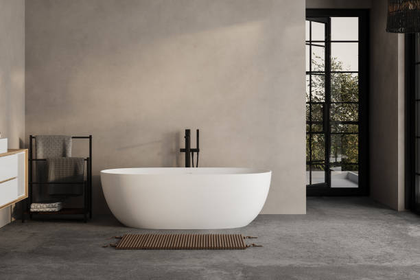 istock Modern minimalist bathroom interior, modern bathroom cabinet, white sink, wooden vanity, interior plants, bathroom accessories, bathtub and shower, white and beige walls, concrete floor. 1902398648