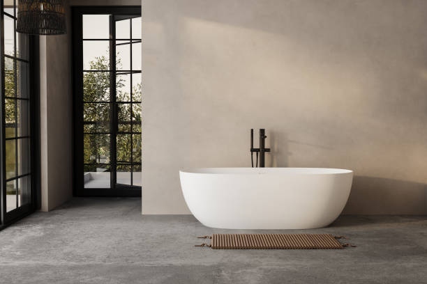 istock Modern minimalist bathroom interior, modern bathroom cabinet, white sink, wooden vanity, interior plants, bathroom accessories, bathtub and shower, white and beige walls, concrete floor. 1902398649