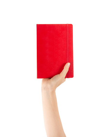 Closeup of woman hand showing red notebook, holding textbooks or organizers, education, reading literature. Indoor studio shot isolated on white background with clipping paths.