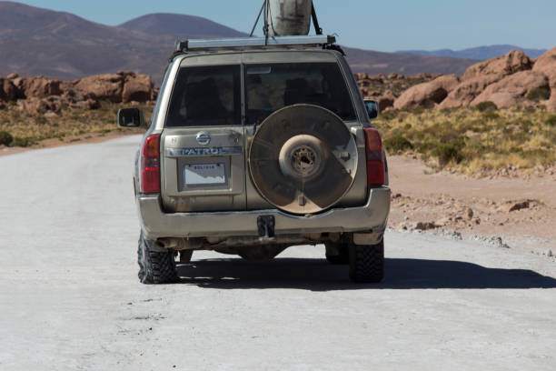 Uyuni area, Bolivia - August 19, 2019: tourists offroad vehicle with punctured tire