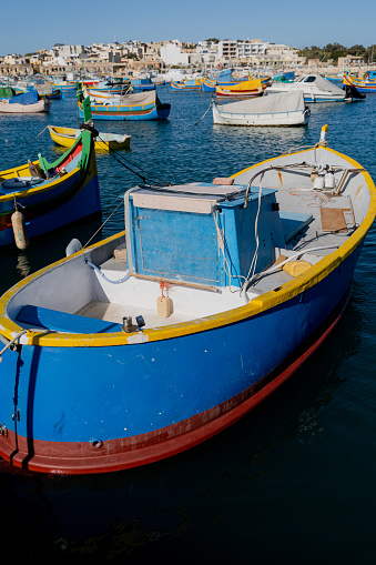 Multi-colored fishing boat. Malta. Overall plan.