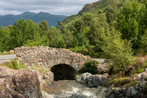 The well-known Ashness Bridge, a traditional packhorse bridge over Barrow Beck, Borrowdale, Lake District, Cumbria, UK