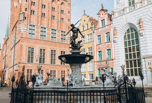 Triton statue on the market square in Gdansk, Poland. Beautiful old houses historical part of downtown, Neptune fountain