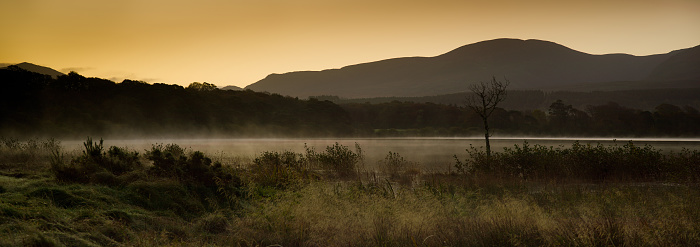 Laugh Leane Killarney, Ireland. Early in the morning, sunrise, dawn. Fog, mist or smoke on the water. Killarney, County Kerry - Republic of Ireland. High resolution panorama.