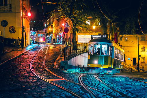 Yellow tram in Alfama at night, Lisbon, Portugal