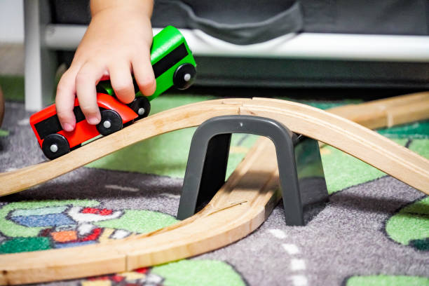 istock Child playing with a wooden train toy 1902583545