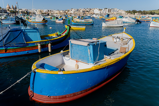 Multi-colored fishing boat. Malta. Overall plan.