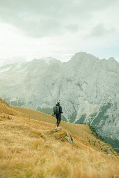 istock Young woman hikes up path in mountains 1902620957