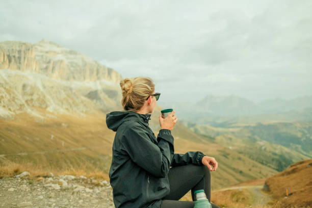 istock Young woman hikes up path in mountains 1902621756