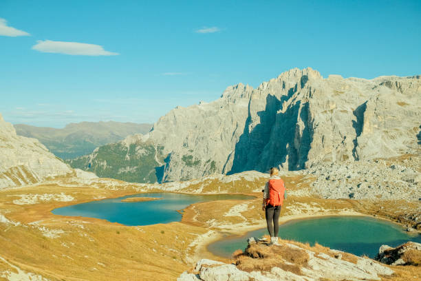 istock Young woman hikes up path in mountains 1902633182