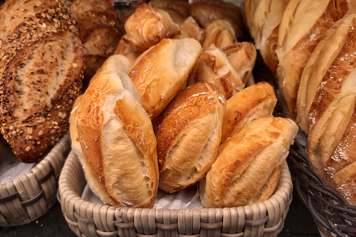 Closeup of a basket of breads on the balcony of a bakery