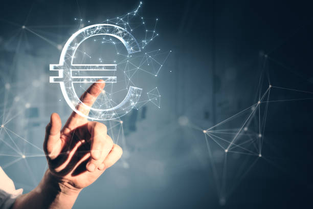Close up of male hand pointing at creative polygonal euro sign on gray wall background. Online banking, money and trade concept. Close up of male hand pointing at creative polygonal euro sign on gray wall background. Online banking, money and trade concept european union currency stock pictures, royalty-free photos & images