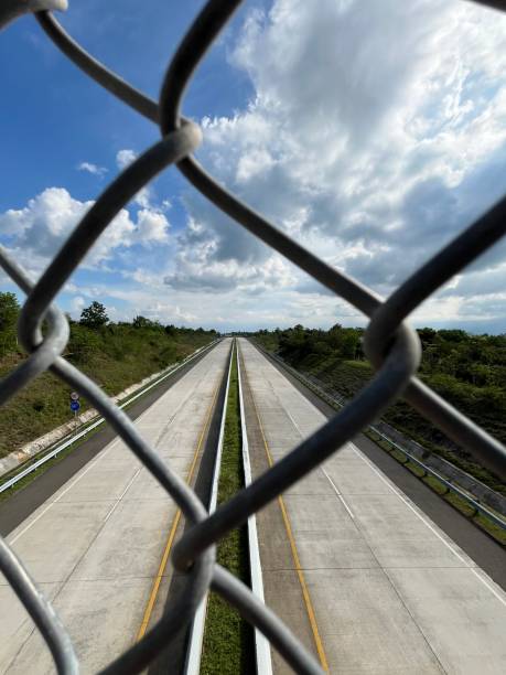 istock A highway in Aceh, Indonesia with iron fence foreground 1902687521