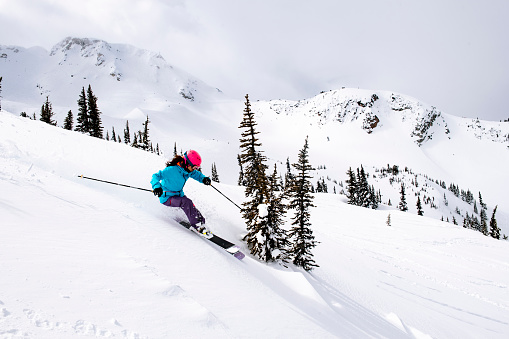 Female skier enjoys moments of fun, Whistler, BC