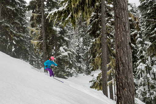 Female skier enjoys moments of fun, Whistler, BC