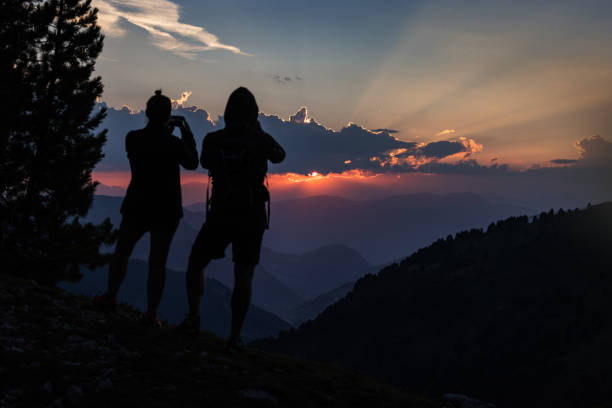 istock Couple hiking outdoors on the Dolomites, enjoying sunset 1902700103