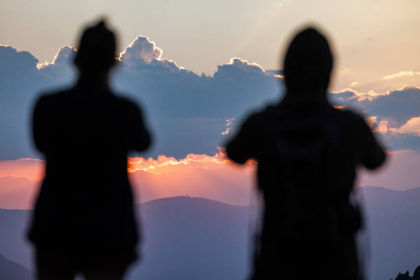 Couple hiking outdoors on the Dolomites, enjoying sunset
