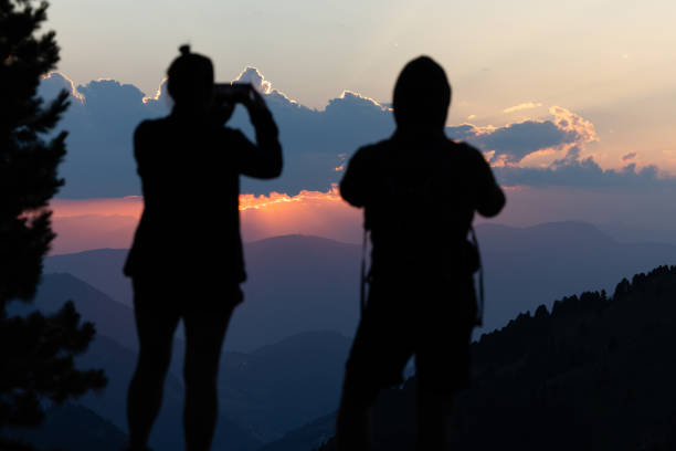 Couple hiking outdoors on the Dolomites, enjoying sunset