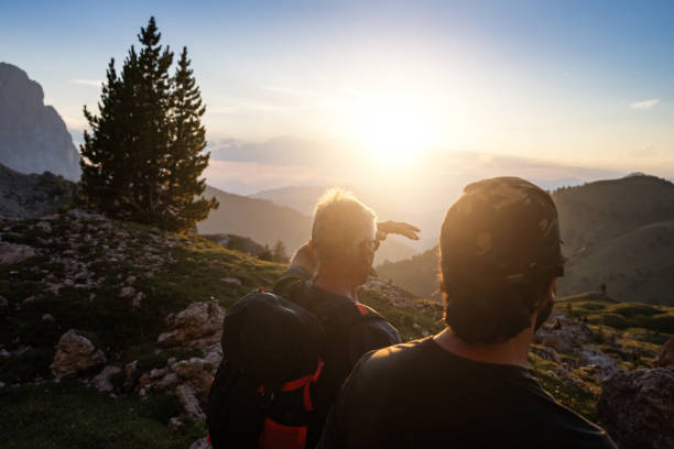 Father and son trail hiking on the Dolomites during summer