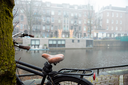 Wet Bicycle in rainy Autumn day in Amsterdam. Copy space