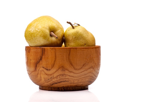 Two ripe pears in a bowl isolated on white background