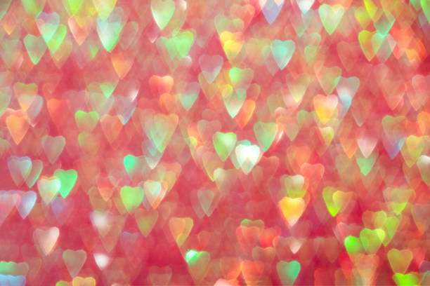 Multicolored hearts, sparkling bokeh, abstract defocused background for Valentine's Day.