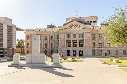 View of the gold dome of the Colorado State Capitol and the bronze sculpture titled \