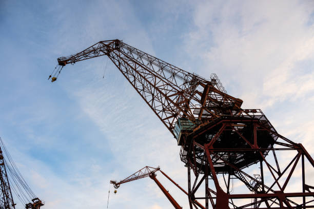 istock Looking up on old wharf cranes.. 1902819257