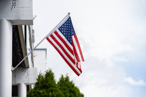 istock American flag hanging from a flag pole on a facade.. 1902824874