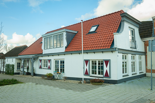 Classic Dutch home with decorative white and red shutters in Waddinxveen, The Netherlands.
