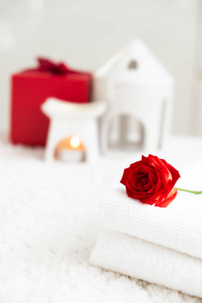 istock White towels and red rose. Romantic SPA. 1902888685