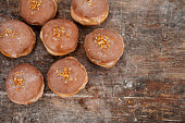 Fat Thursday. Classic golden donuts with icing. Donuts stuffed with marmalade. Polish tradition