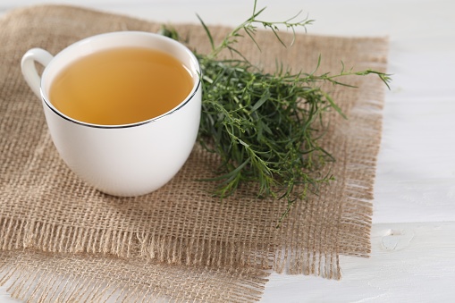 warm green tea on white cloth