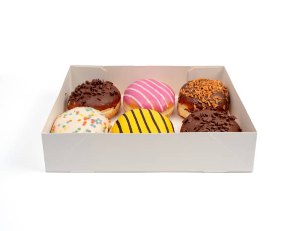 istock Cardboard box with donuts of different flavors isolated on a white background. 1902964738