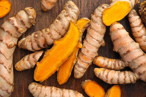 istock Many fresh turmeric roots on wooden table, flat lay 1902973572